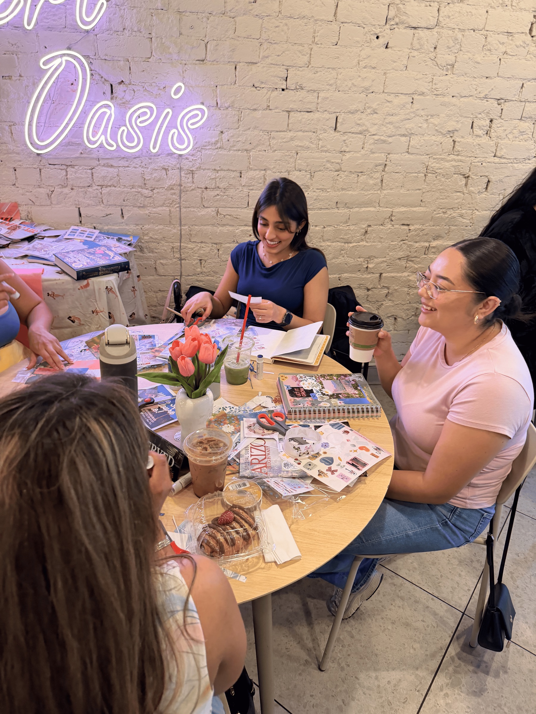 Women crafting together at a Gather and Glow table